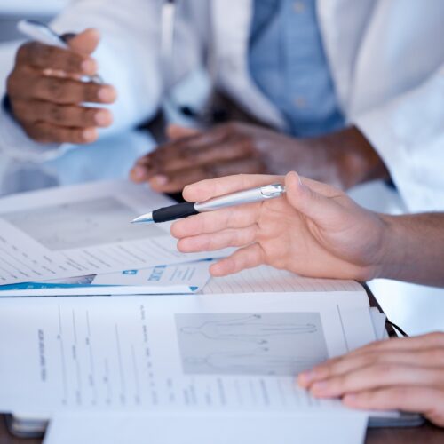 Doctors, hands and paperwork of people for research, healthcare planning and analysis. Hospital sta